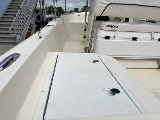 Slide: The Image of 2003 Key West 1720 CC boat interior with Igloo cooler and storage compartment. - 3