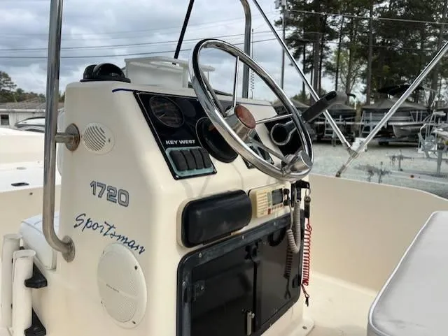 Slide: The Image of 2003 Key West 1720 CC boat dashboard with steering wheel and controls. - 4