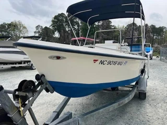 Slide: The Image of 2003 Key West 1720 CC boat on trailer with canopy, parked outdoors. - 5