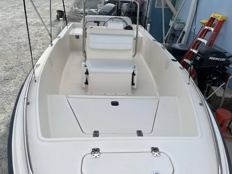 Slide: The Image of 2003 Key West 1720 CC boat interior with seating and storage compartments. - 9