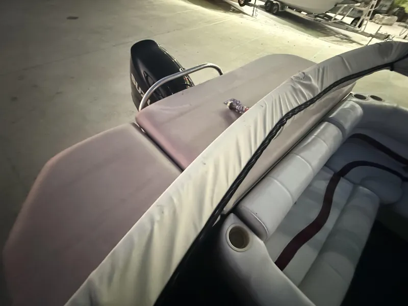 Slide: The Image of 2008 South Bay 25 boat interior with cushioned seating and visible outboard motor. - 11