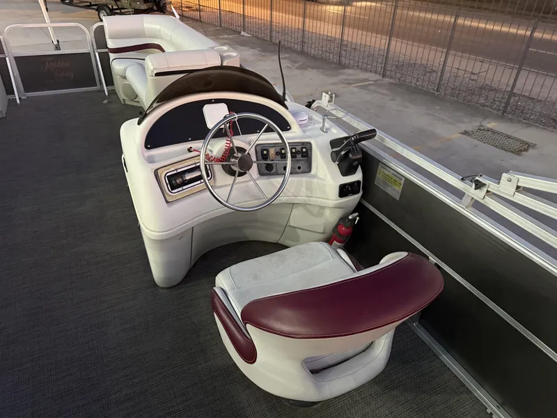 Slide: The Image of 2008 South Bay 25 boat interior with steering wheel and seating area. - 12