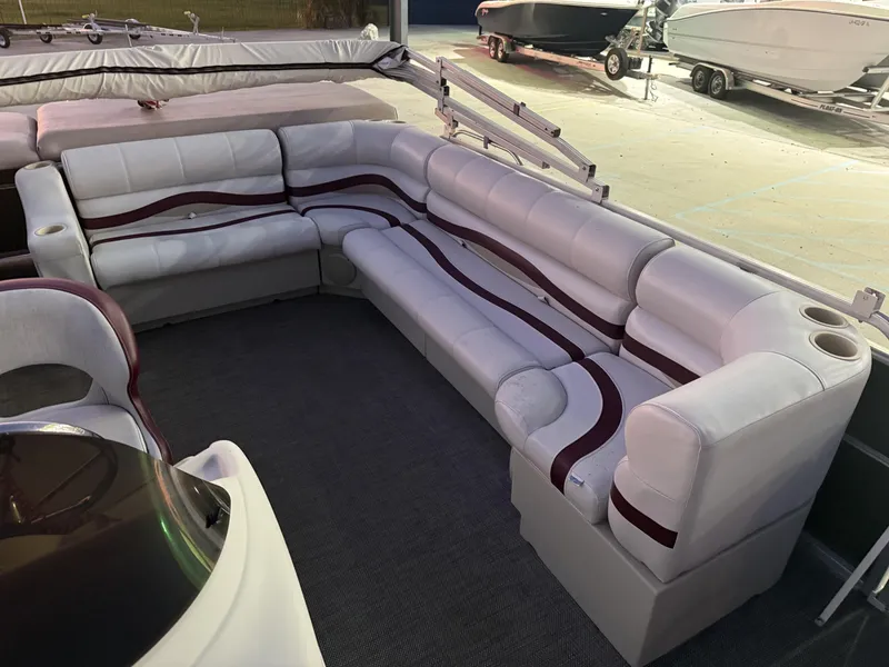 Slide: The Image of 2008 South Bay 25 pontoon boat interior with white and maroon seating. - 9