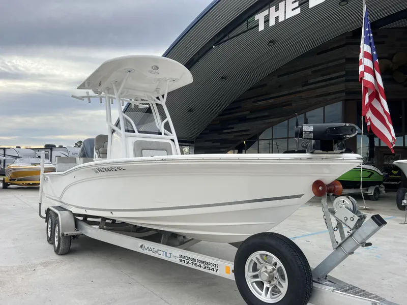 Slide: The Image of 2020 Sea Fox 240 Viper boat on trailer, parked outside dealership with American flag. - 10