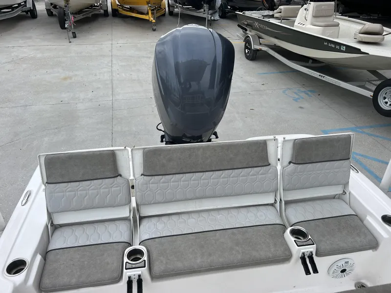 Slide: The Image of 2020 Sea Fox 240 Viper boat with gray seating and outboard motor in a marina. - 2