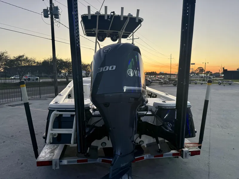 Slide: The Image of 2013 BlackJack 224 boat with Yamaha 300 engine at sunset on a trailer. - 4