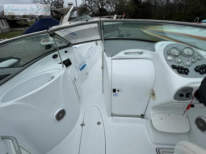 Slide: The Image of 2002 Baja 292 Islander boat interior with white seating and control panel. - 10