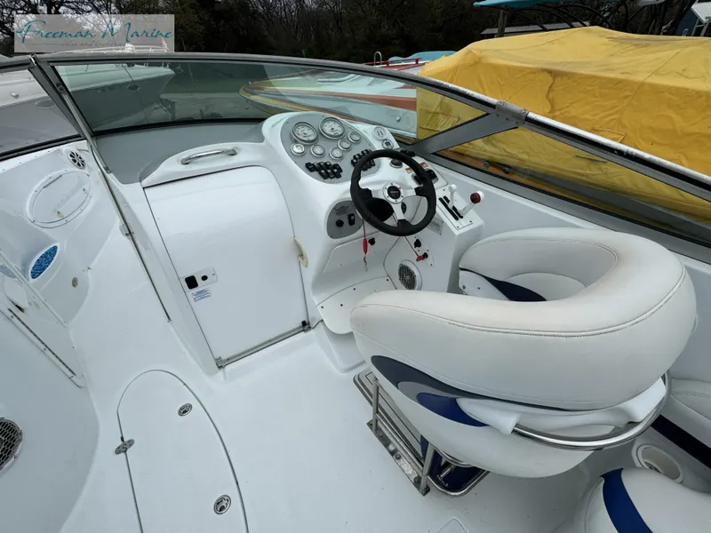 Slide: The Image of 2002 Baja 292 Islander boat cockpit with steering wheel and white seating. - 11