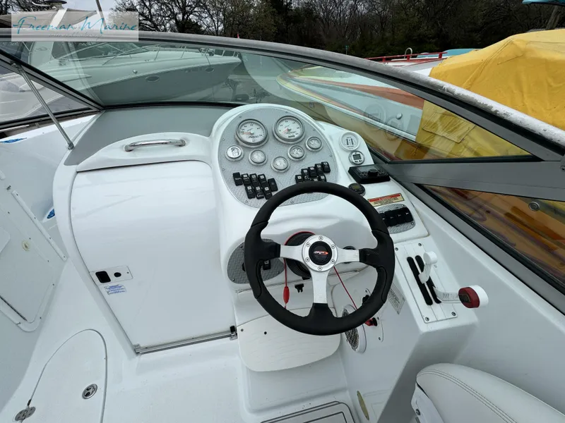 Slide: The Image of 2002 Baja 292 Islander boat cockpit with steering wheel and instrument panel. - 12