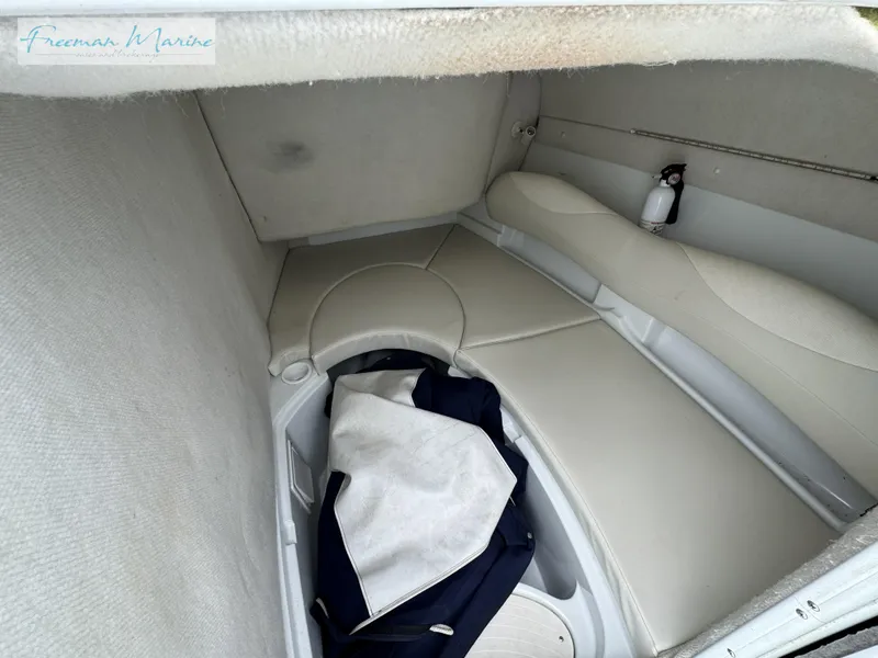 Slide: The Image of 2002 Baja 292 Islander cabin interior with seating and storage. - 15