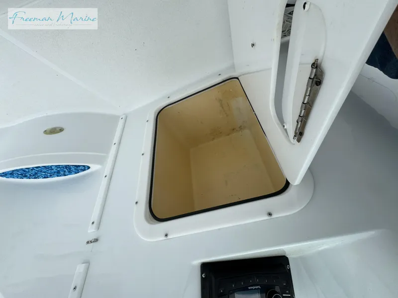 Slide: The Image of Open storage compartment on a 2002 Baja 292 Islander boat interior. - 16