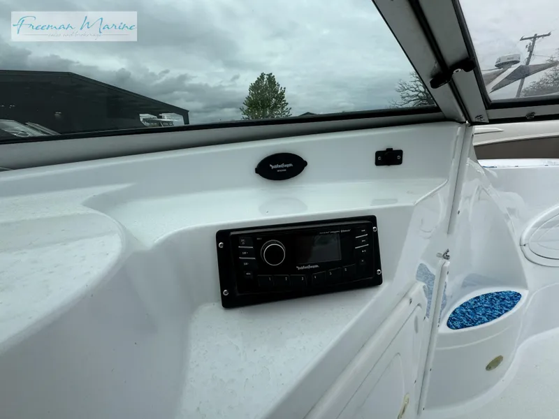 Slide: The Image of 2002 Baja 292 Islander boat dashboard with stereo system and cloudy sky background. - 17