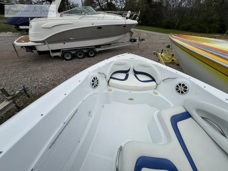 Slide: The Image of 2002 Baja 292 Islander boat interior with seating, parked alongside other boats. - 20