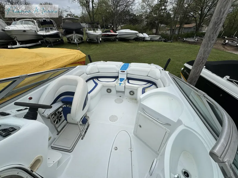 Slide: The Image of 2002 Baja 292 Islander boat interior with seating and control panel, surrounded by other boats. - 21
