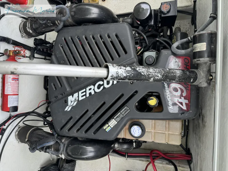 Slide: The Image of Engine compartment of a 2002 Baja 292 Islander boat with Mercury engine components. - 26