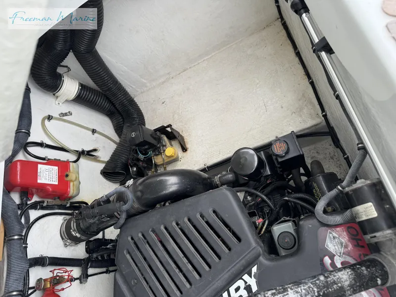 Slide: The Image of Engine compartment of a 2002 Baja 292 Islander boat, showing mechanical components and wiring. - 27