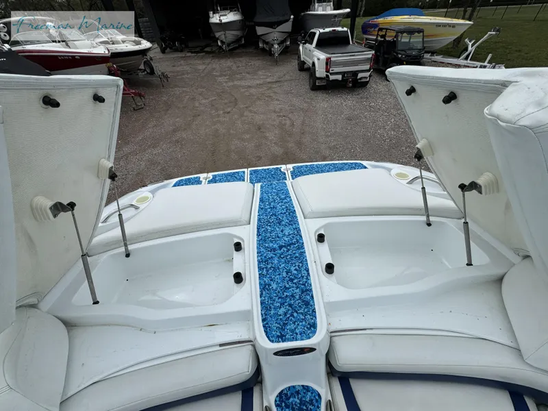 Slide: The Image of 2002 Baja 292 Islander boat interior with open storage compartments. - 31