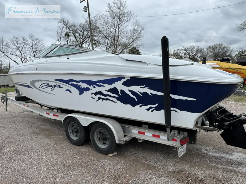 Slide: The Image of 2002 Baja 292 Islander boat on trailer, featuring sleek design and blue graphics. - 6