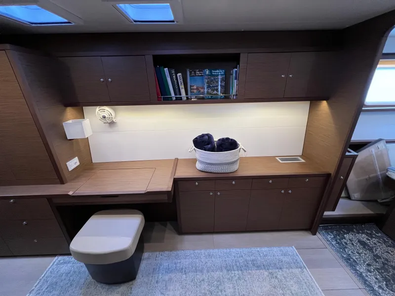 Slide: The Image of Interior of 2019 Lagoon 450 F yacht with wooden cabinetry and cozy seating area. - 14