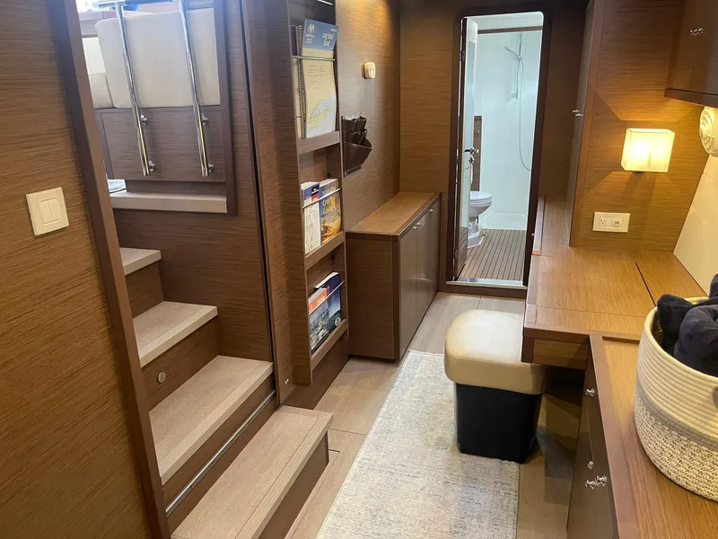 Slide: The Image of Interior of 2019 Lagoon 450 F yacht featuring wooden decor, stairs, and a cozy seating area. - 15