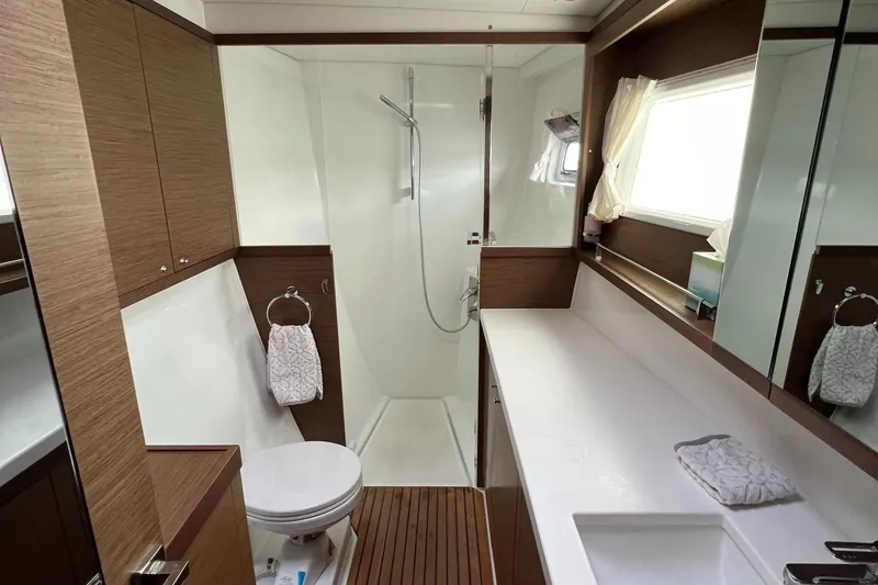Slide: The Image of Modern bathroom in 2019 Lagoon 450 F yacht with shower, toilet, and wooden accents. - 16