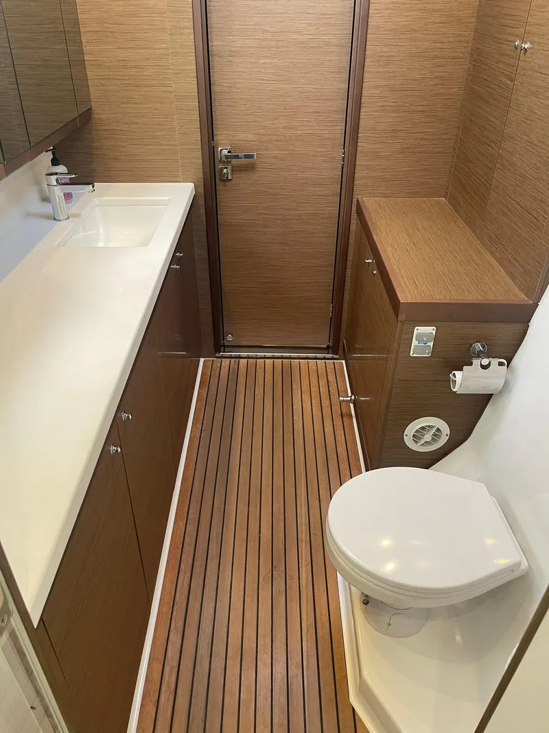 Slide: The Image of 2019 Lagoon 450 F yacht bathroom with wood flooring and modern fixtures. - 17