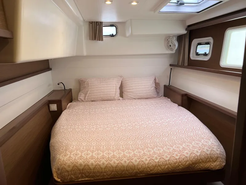 Slide: The Image of Cozy bedroom in 2019 Lagoon 450 F yacht with double bed and porthole windows. - 18