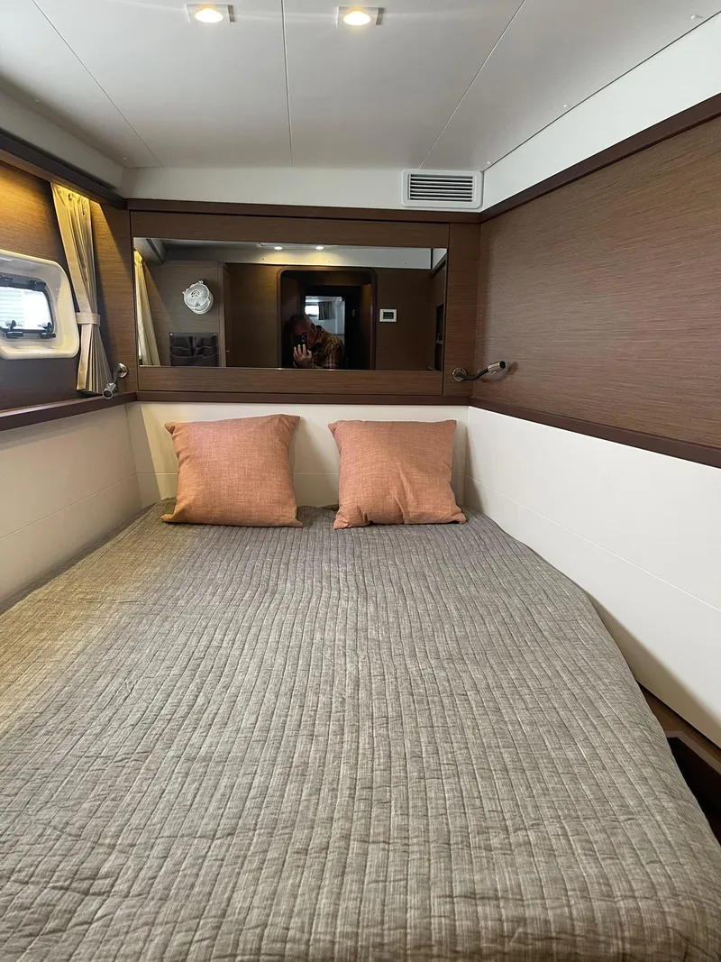 Slide: The Image of Interior cabin of 2019 Lagoon 450 F catamaran with cozy bed and pillows. - 22