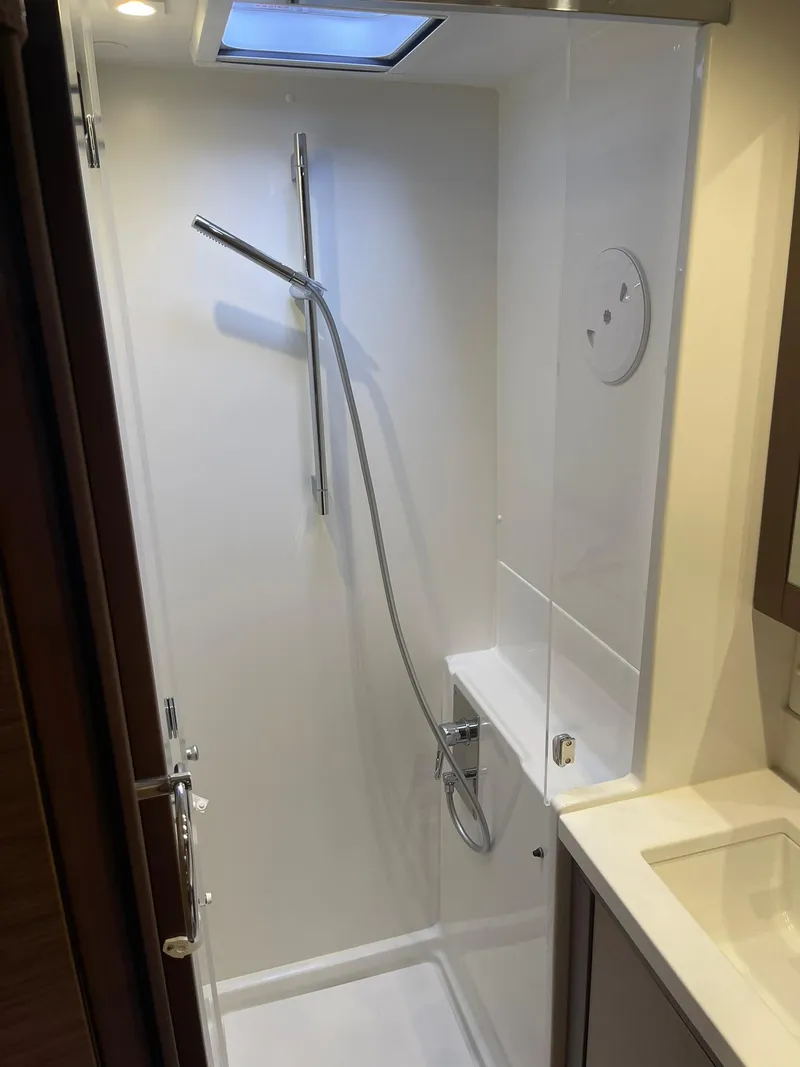 Slide: The Image of Modern shower in 2019 Lagoon 450 F yacht, featuring sleek design and skylight. - 23