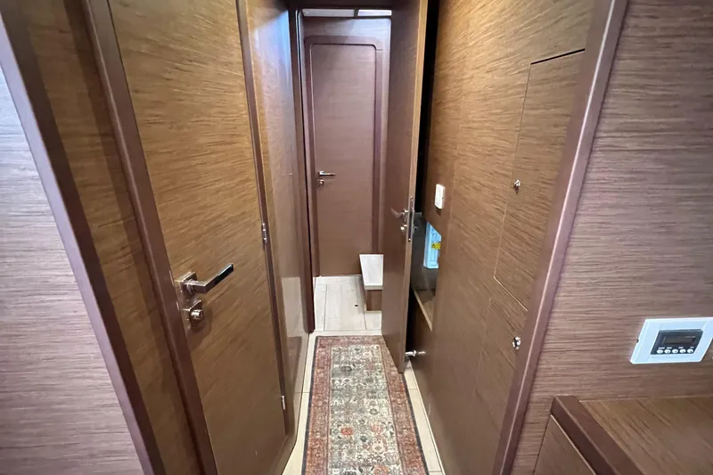 Slide: The Image of Interior hallway of 2019 Lagoon 450 F yacht with wooden finish and carpet. - 27