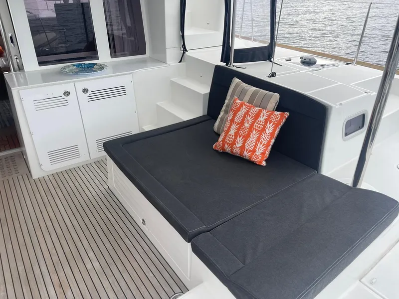 Slide: The Image of 2019 Lagoon 450 F yacht interior with cushioned seating and decorative pillows. - 43