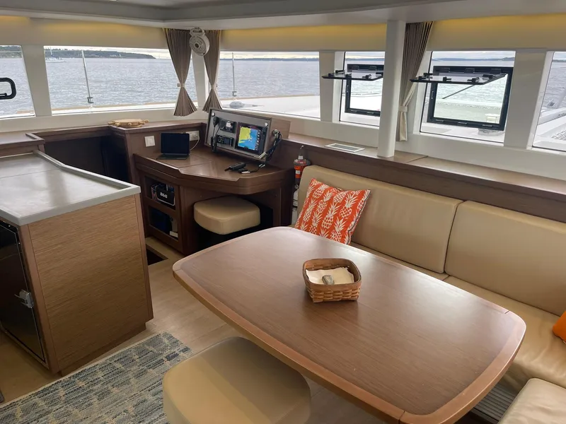 Slide: The Image of Interior of 2019 Lagoon 450 F catamaran with dining area and navigation station. - 8