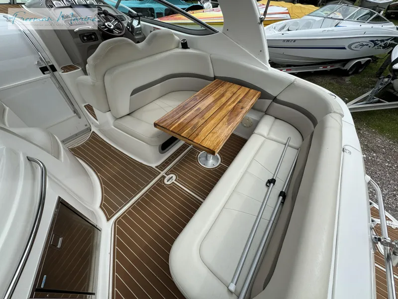 Slide: The Image of 2008 Chaparral Signature 290 boat interior with seating and wooden table. - 11