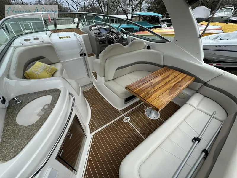 Slide: The Image of 2008 Chaparral Signature 290 boat interior with seating, wooden table, and helm. - 12