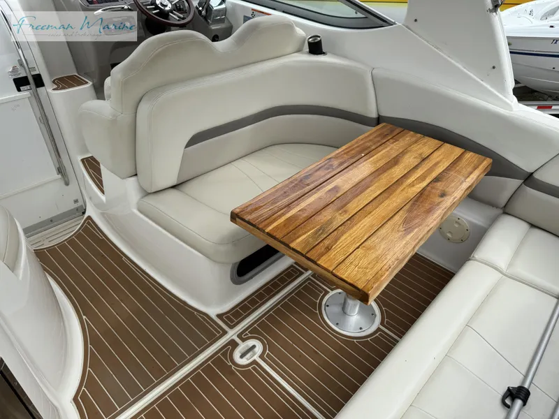 Slide: The Image of 2008 Chaparral Signature 290 interior with wooden table and white seating. - 13