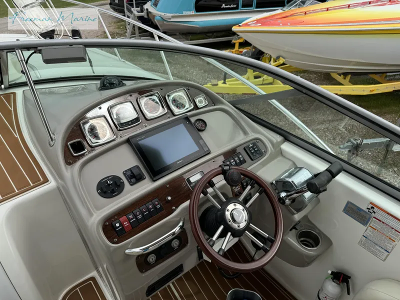 Slide: The Image of 2008 Chaparral Signature 290 dashboard with steering wheel and navigation controls. - 19