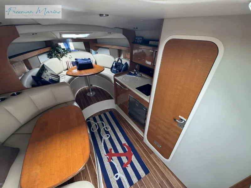 Slide: The Image of 2008 Chaparral Signature 290 interior with seating, kitchenette, and nautical decor. - 24