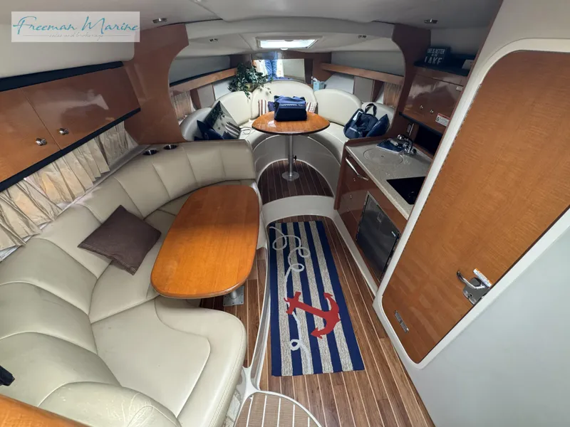 Slide: The Image of 2008 Chaparral Signature 290 interior with seating, table, and kitchenette. - 25