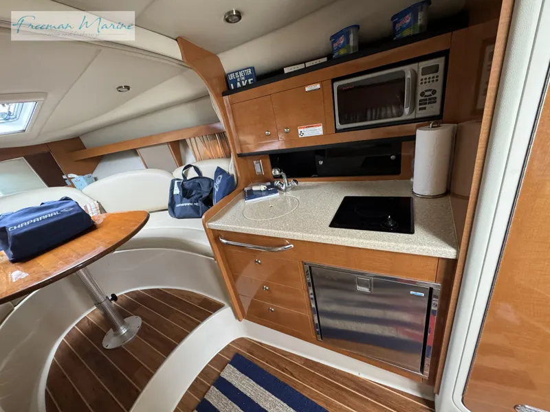 Slide: The Image of 2008 Chaparral Signature 290 interior with kitchenette, microwave, and seating area. - 28