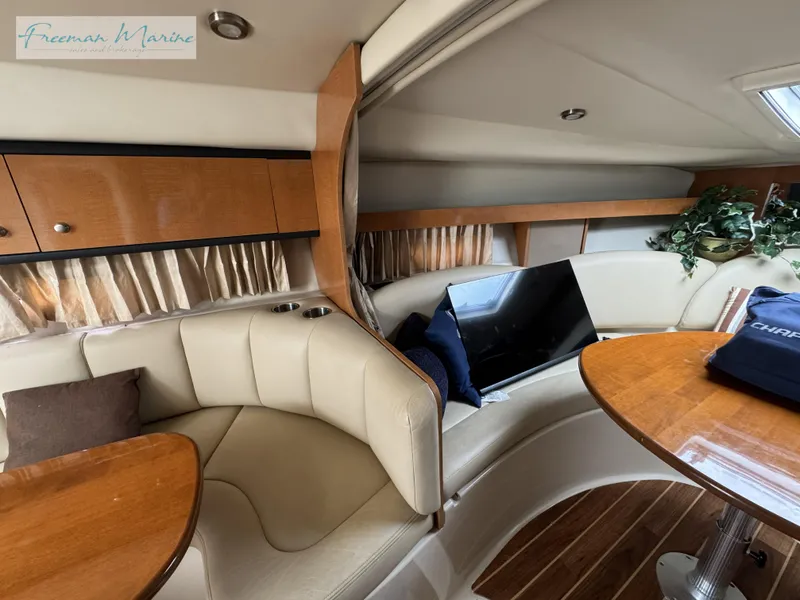 Slide: The Image of 2008 Chaparral Signature 290 interior with cozy seating, wooden table, and TV. - 29