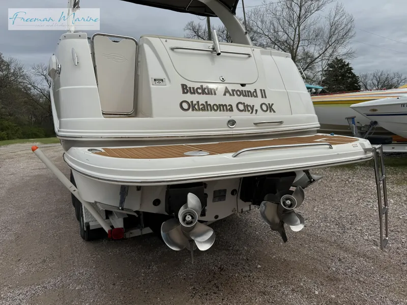 Slide: The Image of 2008 Chaparral Signature 290 boat, rear view, with dual propellers, named "Buckin' Around II." - 3