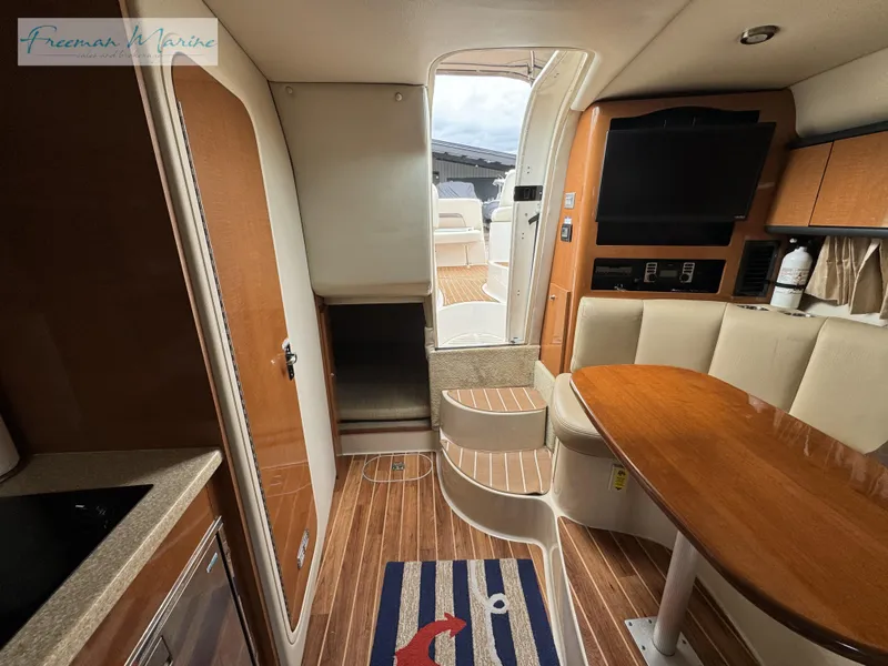 Slide: The Image of 2008 Chaparral Signature 290 interior with wood flooring, dining area, and steps to deck. - 32