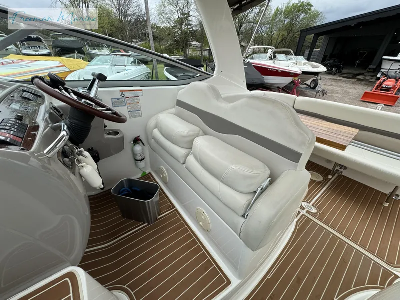 Slide: The Image of 2008 Chaparral Signature 290 boat interior with helm, seating, and wood-patterned flooring. - 33