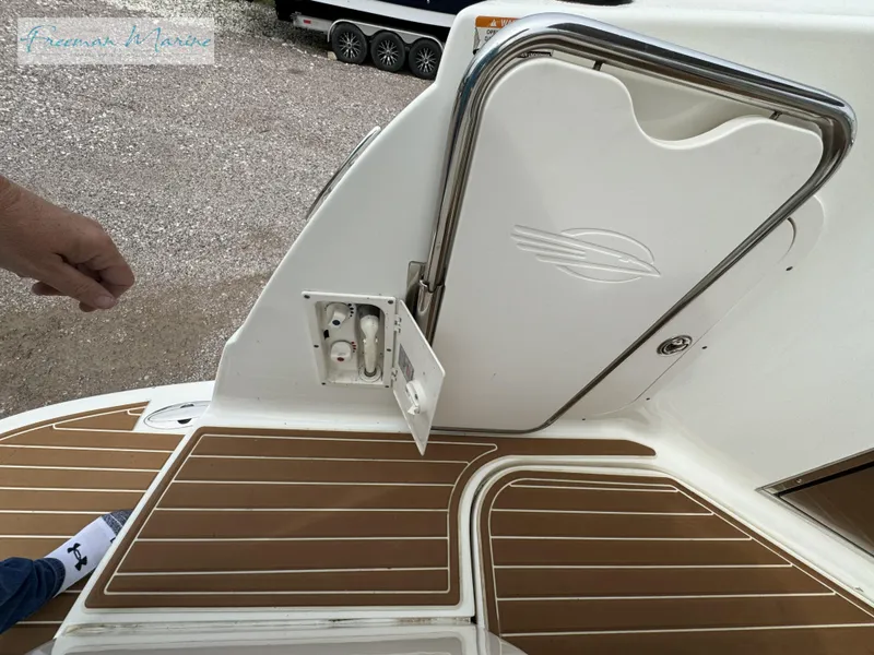 Slide: The Image of 2008 Chaparral Signature 290 boat deck with open hatch and wood-patterned flooring. - 8
