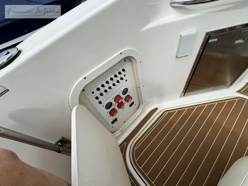 Slide: The Image of 2008 Chaparral Signature 290 boat interior with control panel and wood-patterned flooring. - 9