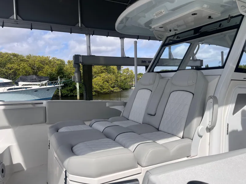 Slide: The Image of 2021 Sea Fox 368 Commander boat interior with cushioned seating under canopy. - 15