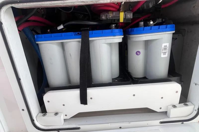 Slide: The Image of Battery compartment of 2021 Sea Fox 368 Commander boat, featuring dual marine batteries. - 20
