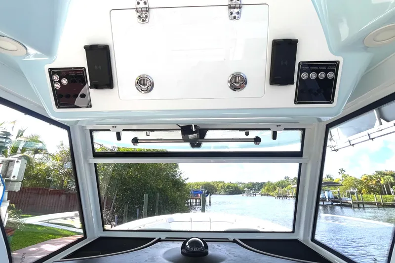 Slide: The Image of Interior view of 2021 Sea Fox 368 Commander boat, showcasing dashboard and waterway scenery. - 22