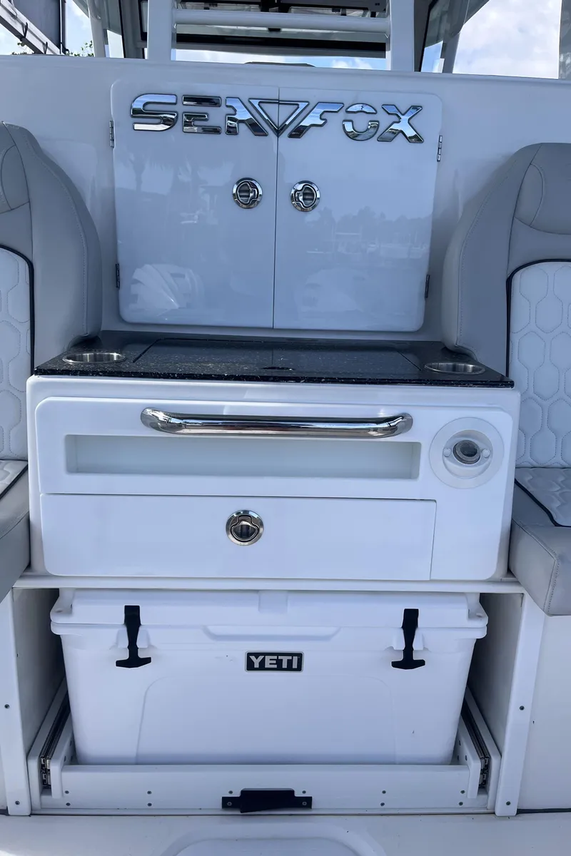 Slide: The Image of 2021 Sea Fox 368 Commander boat interior with Yeti cooler and storage compartments. - 26