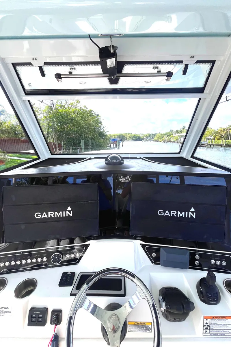 Slide: The Image of 2021 Sea Fox 368 Commander helm with dual Garmin displays and modern navigation controls. - 4